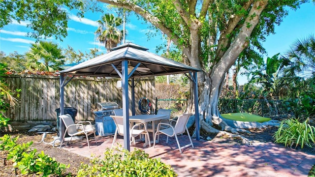 view of patio featuring a gazebo and a grill