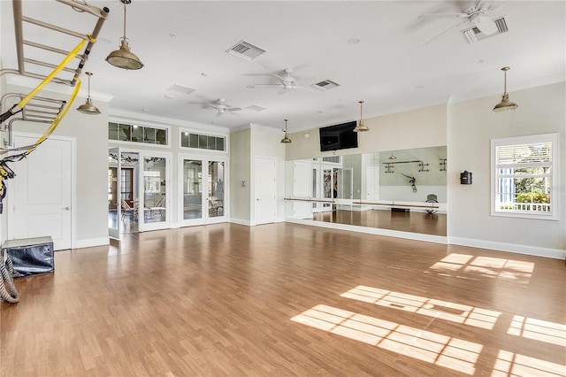 workout room featuring crown molding, hardwood / wood-style floors, and ceiling fan