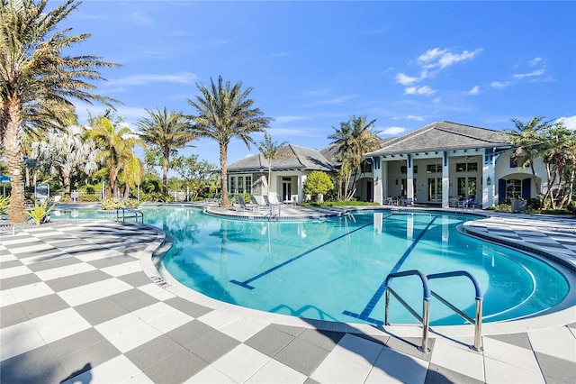 view of pool with a patio area and ceiling fan