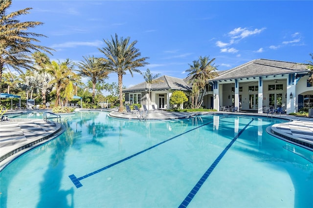 view of swimming pool with ceiling fan and a patio