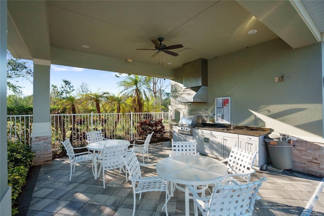 view of patio with area for grilling and ceiling fan