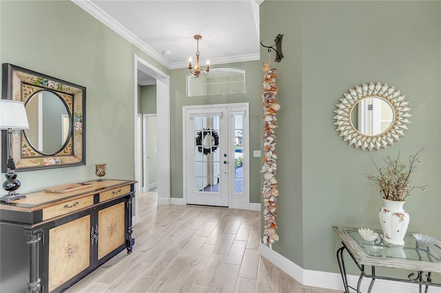 entryway featuring an inviting chandelier, light hardwood / wood-style floors, and ornamental molding