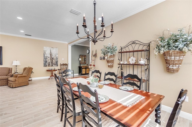 dining room with crown molding, light hardwood / wood-style flooring, and a chandelier