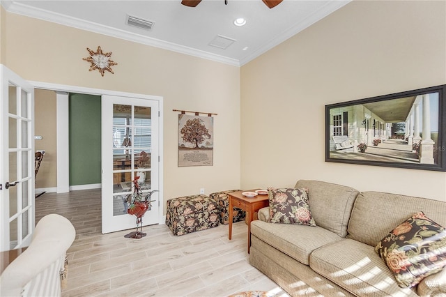 living room with ceiling fan, light hardwood / wood-style flooring, crown molding, and french doors