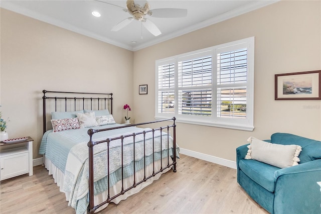 bedroom featuring ceiling fan, light wood-type flooring, and crown molding