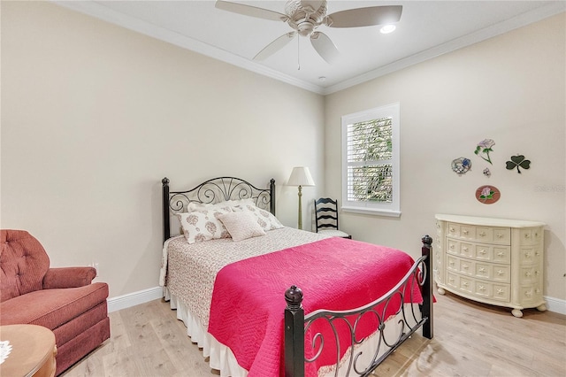 bedroom featuring ceiling fan, crown molding, and light hardwood / wood-style flooring