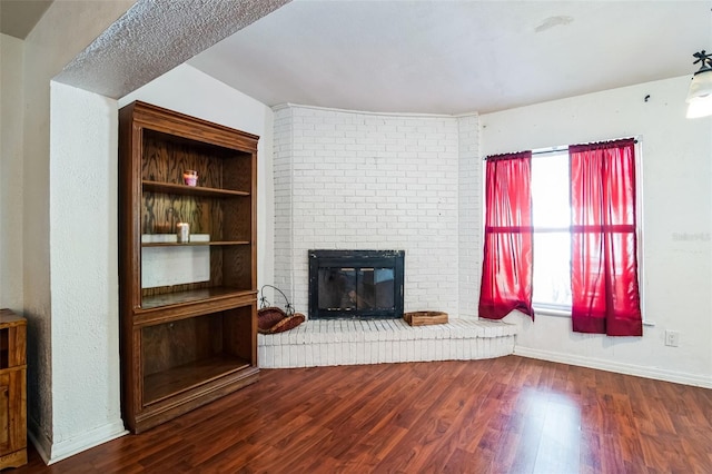 unfurnished living room featuring hardwood / wood-style floors and a fireplace