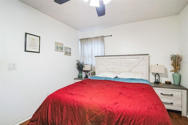 bedroom with ceiling fan and dark wood-type flooring