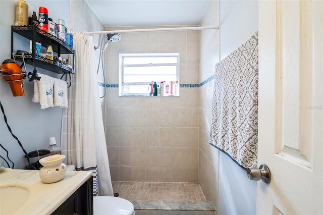 bathroom featuring vanity, a shower with shower curtain, and toilet