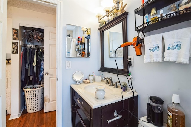 bathroom with vanity, a textured ceiling, and hardwood / wood-style flooring