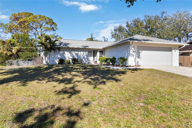 ranch-style house featuring a garage and a front lawn