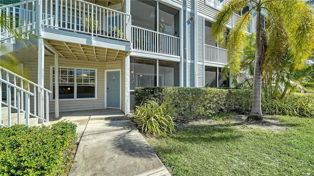 entrance to property featuring a yard