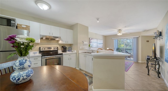 kitchen featuring white cabinetry, stainless steel appliances, and kitchen peninsula