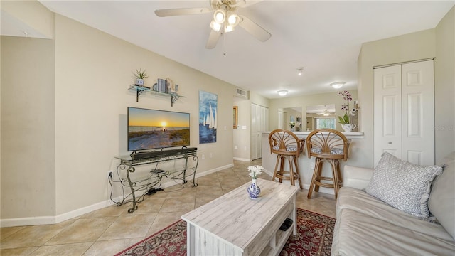 living room with light tile patterned floors and ceiling fan