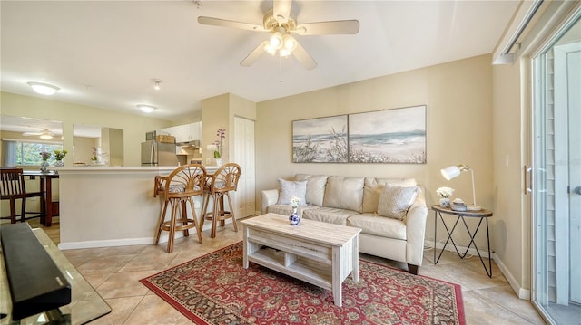 tiled living room featuring ceiling fan