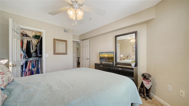 bedroom with ceiling fan and a closet