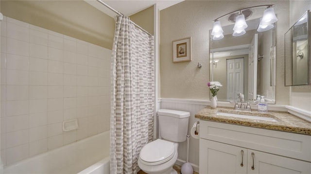 full bathroom featuring toilet, vanity, and shower / bathtub combination with curtain