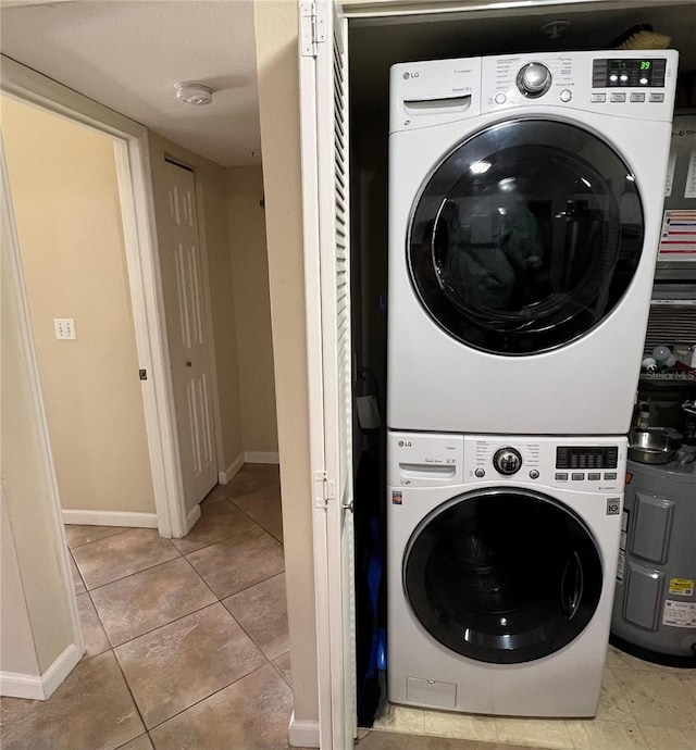 clothes washing area with stacked washer and dryer and light tile patterned floors