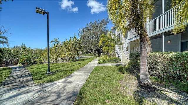 view of property's community with a lawn