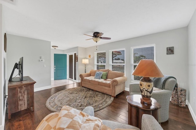 living room featuring ceiling fan and dark hardwood / wood-style floors