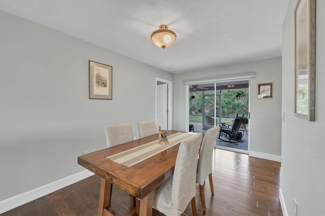 dining space with dark hardwood / wood-style flooring