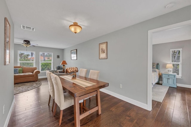 dining space featuring ceiling fan and dark hardwood / wood-style flooring