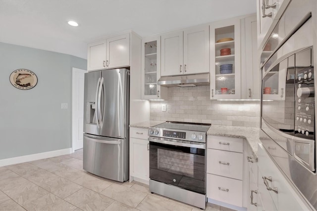 kitchen featuring light stone counters, backsplash, white cabinets, and stainless steel appliances