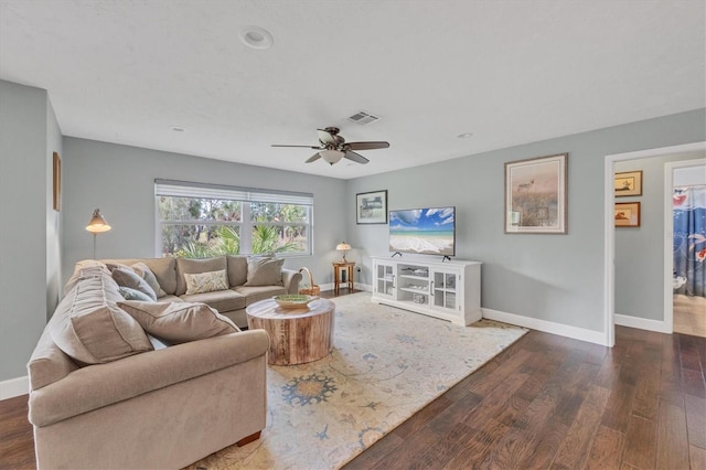 living room with ceiling fan and dark wood-type flooring