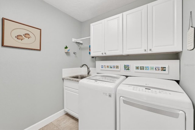 washroom featuring cabinets, separate washer and dryer, light tile patterned floors, and sink