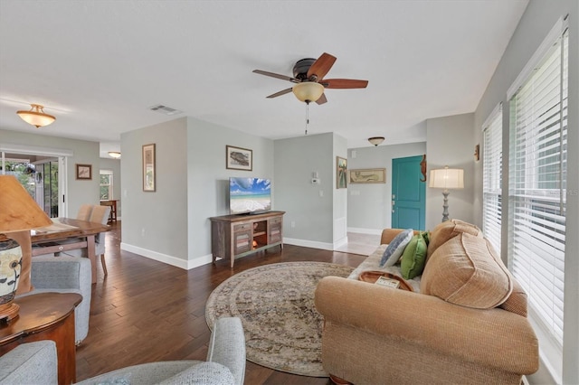 living room with ceiling fan and dark hardwood / wood-style flooring