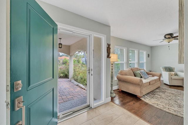 doorway featuring ceiling fan and light wood-type flooring