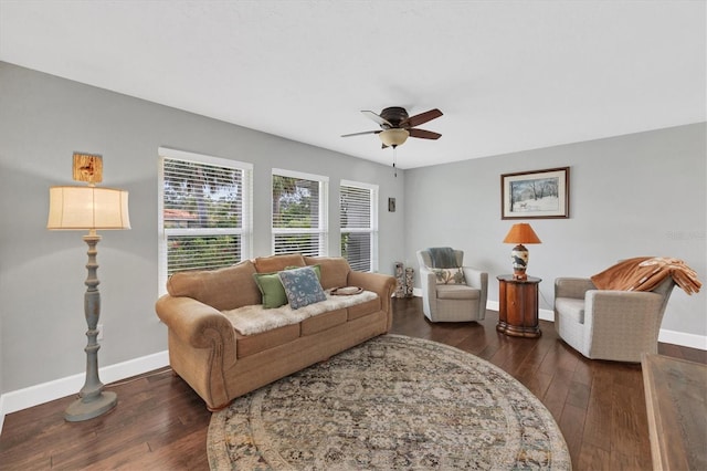 living room featuring ceiling fan and dark hardwood / wood-style flooring