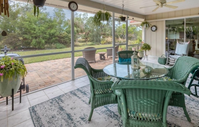 sunroom / solarium featuring ceiling fan