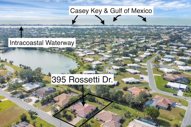 birds eye view of property featuring a water view and a residential view