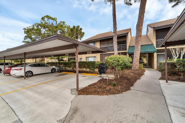 view of parking / parking lot featuring a carport