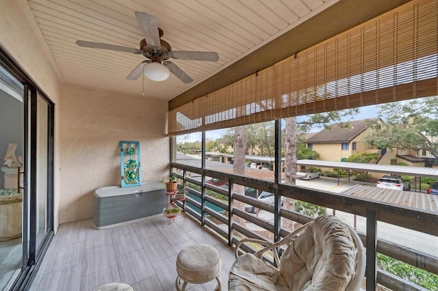 sunroom featuring ceiling fan and wooden ceiling