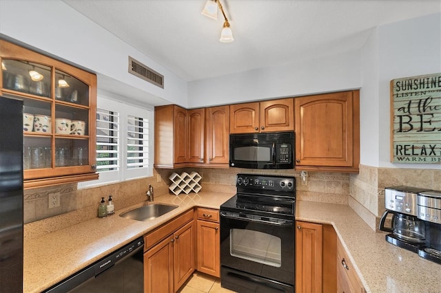 kitchen featuring light tile patterned floors, black appliances, tasteful backsplash, rail lighting, and sink