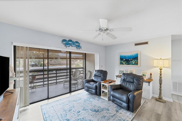 sitting room with ceiling fan and light hardwood / wood-style flooring