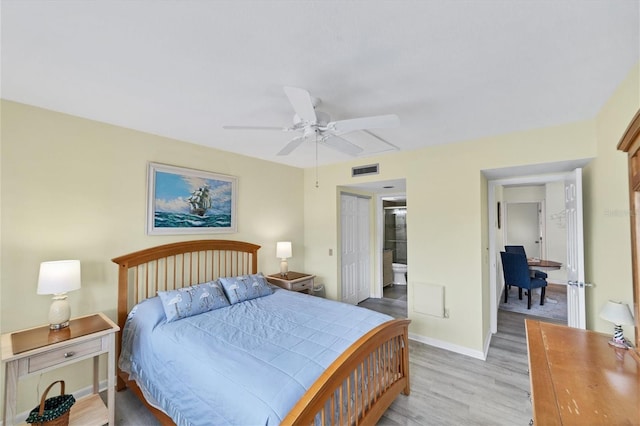 bedroom with ensuite bath, ceiling fan, and light hardwood / wood-style flooring