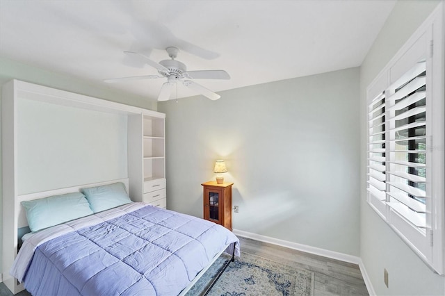 bedroom with ceiling fan and hardwood / wood-style floors