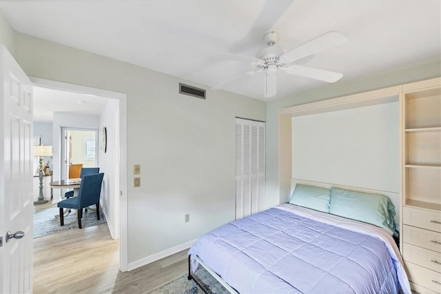 bedroom featuring hardwood / wood-style flooring, ceiling fan, and a closet