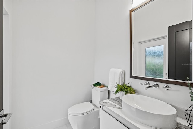 bathroom featuring toilet and vanity