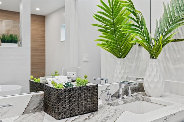 bathroom featuring vanity and a tub