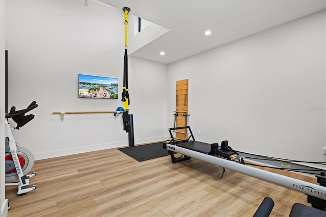 workout room with light hardwood / wood-style floors