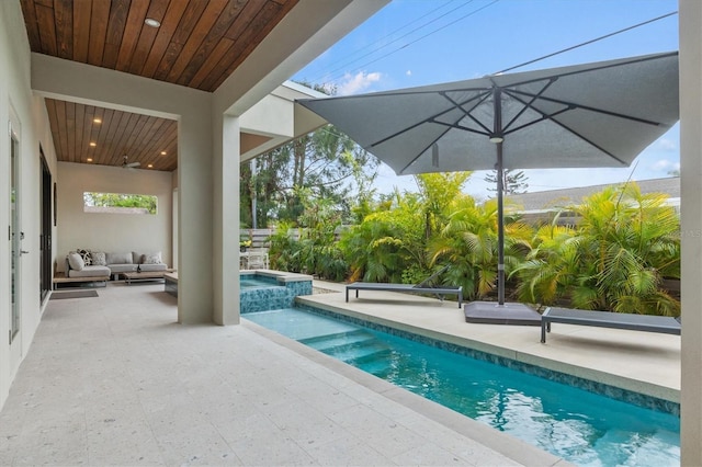 view of pool featuring an outdoor living space, a patio area, and an in ground hot tub