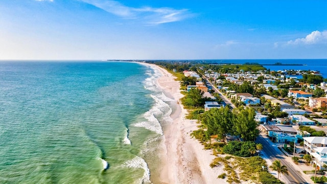 bird's eye view with a water view and a beach view