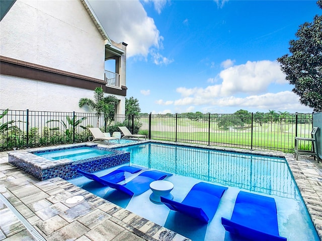 view of swimming pool with an in ground hot tub