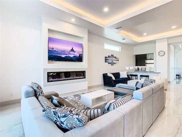 living room with a tray ceiling