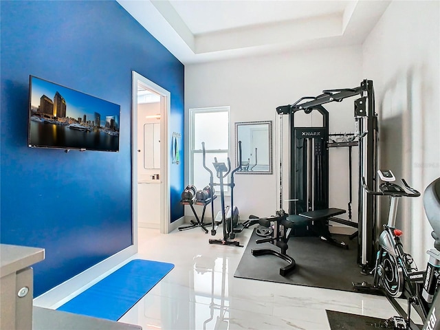 exercise area featuring a tray ceiling