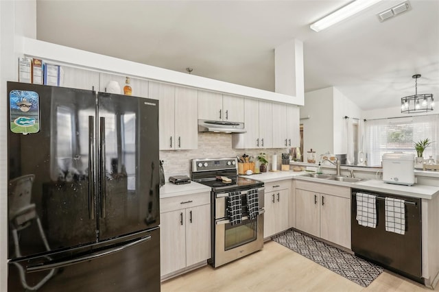 kitchen featuring black appliances, hanging light fixtures, decorative backsplash, sink, and an inviting chandelier